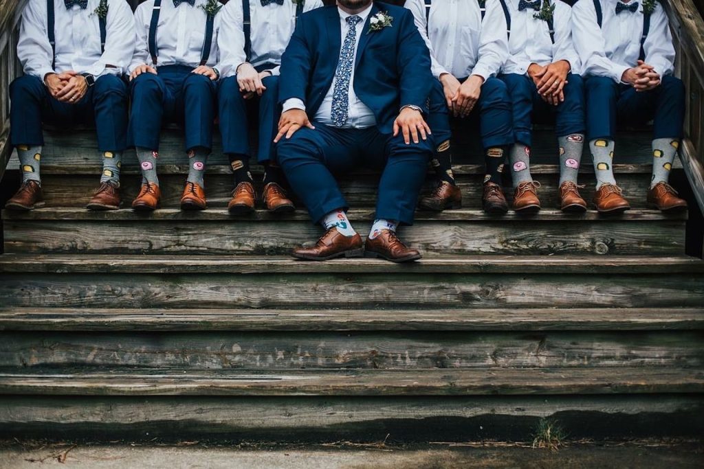 group of men sitting on concrete stairs